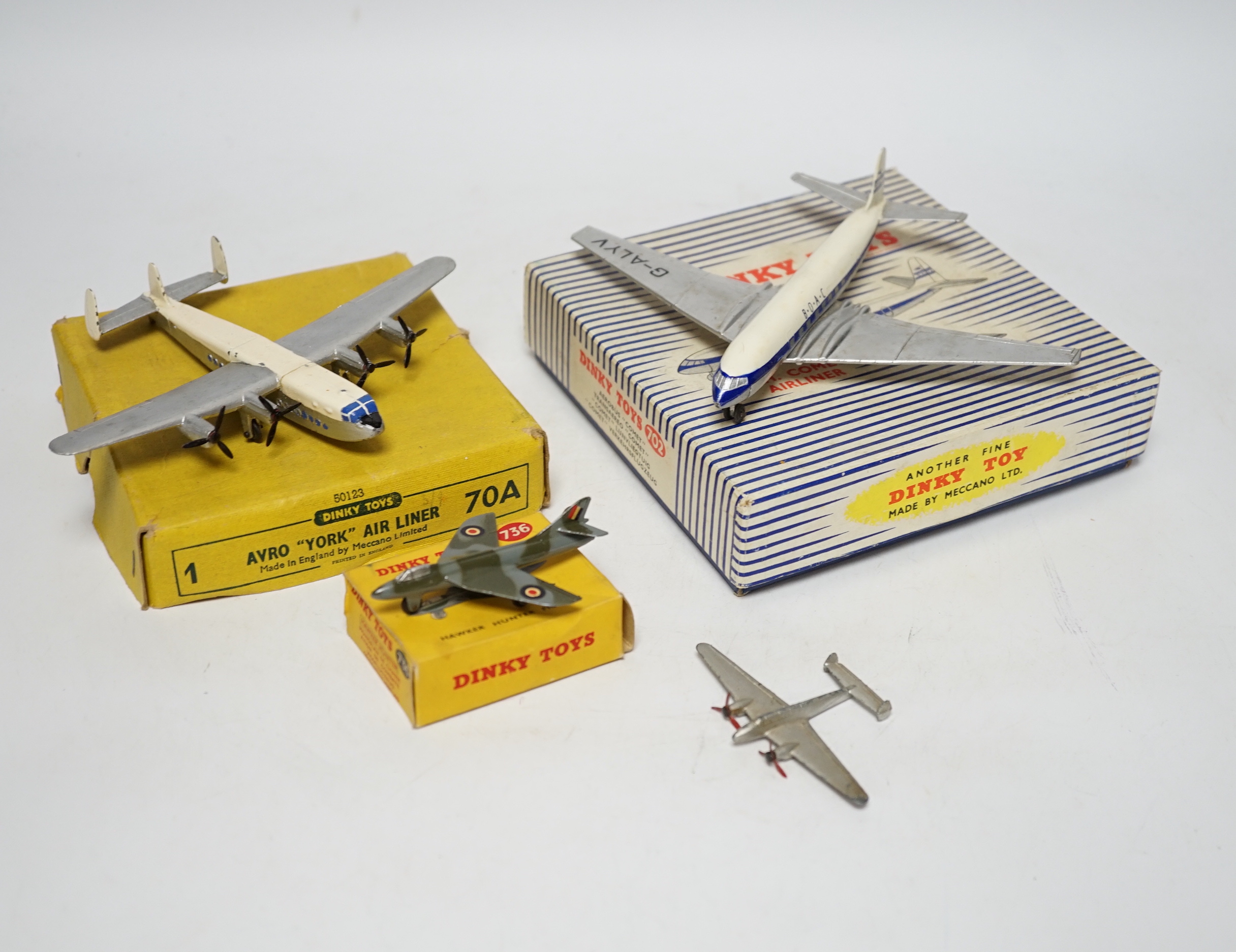Four Dinky Toys aircraft; three boxed examples including (702) DH Comet Airliner, (70A) Avro York Airliner, (736) Hawker Hunter Fighter, and an unboxed Twin Engined Fighter